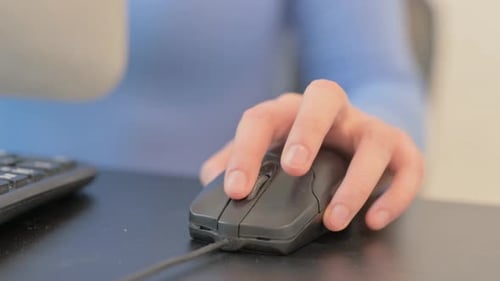 Close up of Woman Using Computer Mouse