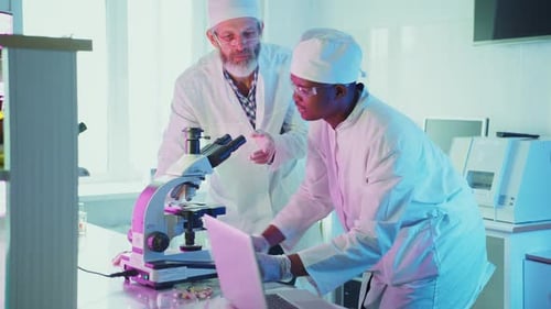 Scientists Collaborating on Research in Modern Lab