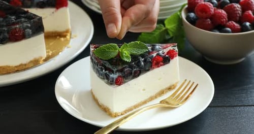 Berry Cheesecake Slice Garnished with Mint, Raspberries and Blueberries
