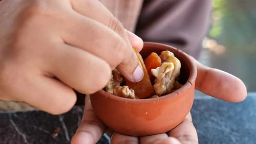 Women Hand Pick Walnut and Dried Peach Fruit