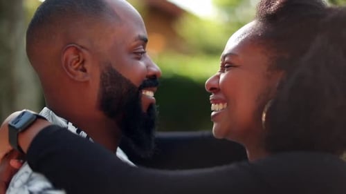 Smiling Couple Embrace Affectionately Outdoors in Natural Light