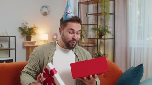 Man Excitedly Opens Birthday Gift at Home