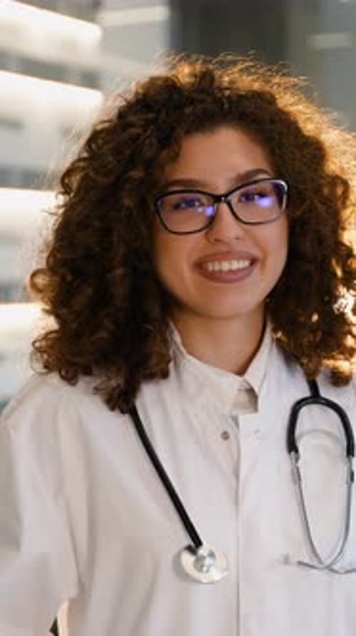 Smiling Woman Doctor in White Coat with Stethoscope