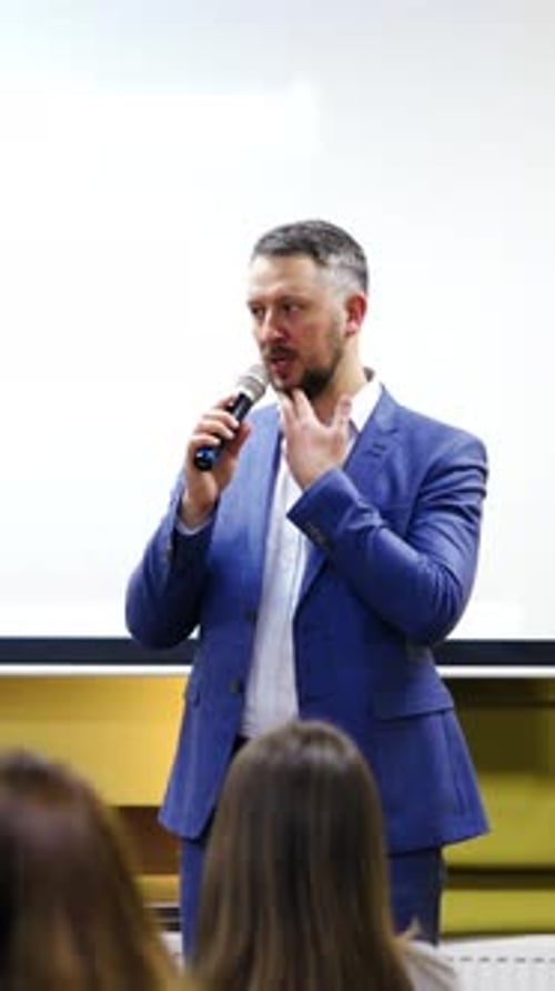 Man Giving Professional Presentation with Microphone
