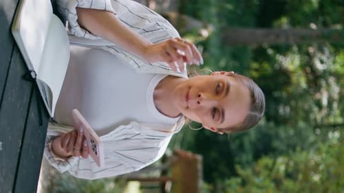 Girl Writer Noting Information Copybook From Mobile in Forest Close Up Vertical