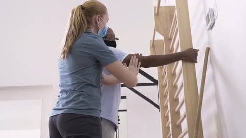 Man Receives Physical Therapy Assisted Arm Stretches