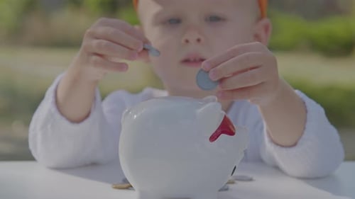 Three Year Old Boy Collect Coins In Piggy Bank In Home Garden 3