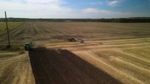 Tractors plowing the field in Ukraine