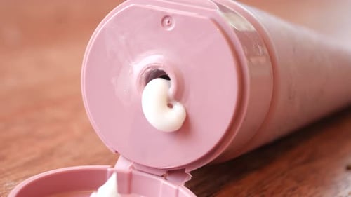 Cream Oozing from a Pink Tube Container