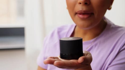 Smiling Woman Using Smart Home Speaker
