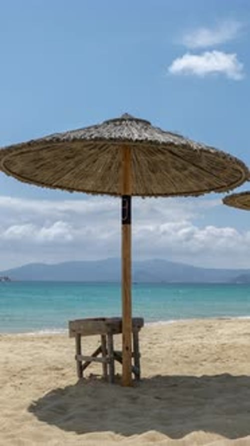 Maragkas Beach in Naxos Island Greece with Sun Umbrellas in Vertical