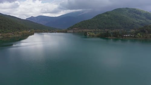 Aerial view of a Lake with trees and mountains in the background