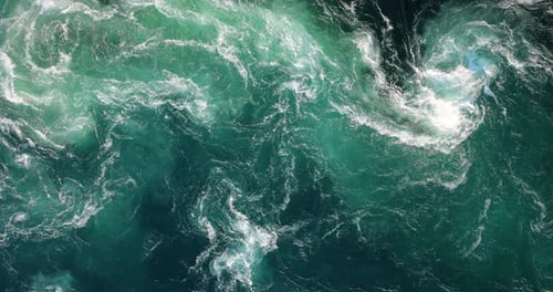 Blue waves of water of the river and the sea meet each other during high tide and low tide.