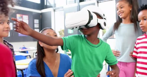 In school, children using VR headset with teacher guiding in classroom activity