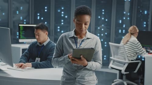 Team Working in Data Center with Tablet and Computers