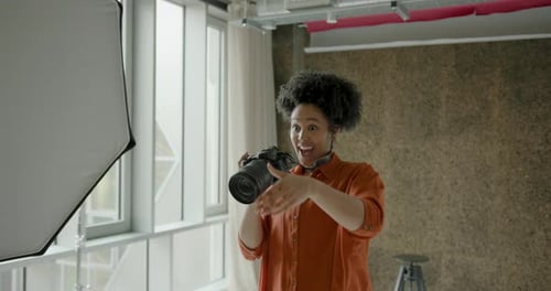 African American Female Photographer in Studio Photographing