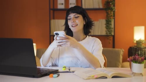 Woman at Desk Using Mobile Device