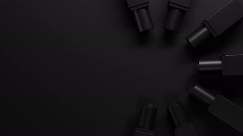 Top View on Black Lipsticks Set Twists Up From Black Tubes on Dark Backdrop Lipstick Group Extend