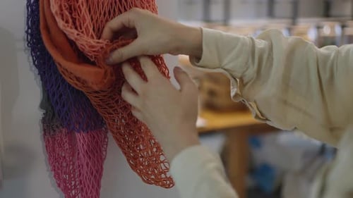 Woman Chooses Organic Mesh Bag for Products in Supermarket