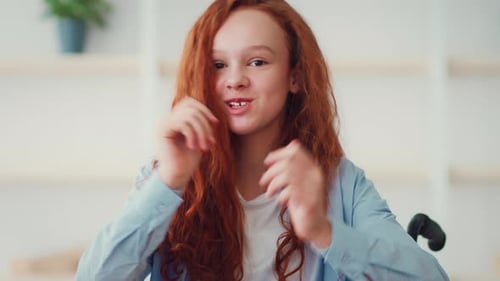 Smiling Teen with Wavy Auburn Hair Indoors