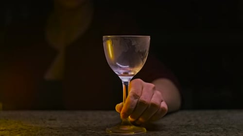 Green Cocktail Being Prepared By a Bartender