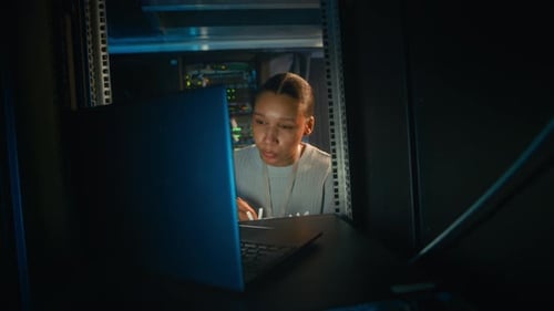 Adult Works With Cables In Server Room