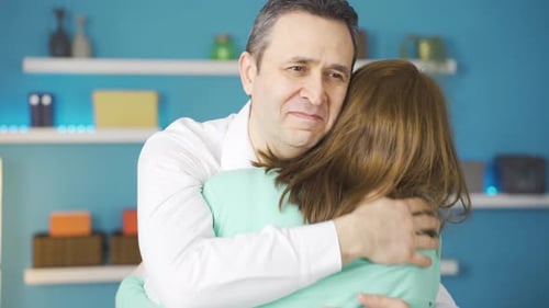 Affectionate Embrace Between a Man and Woman Indoors