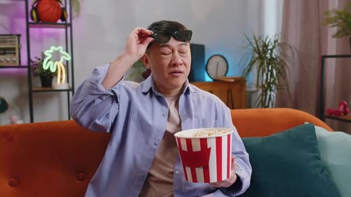 Man in 3D Glasses Eating Popcorn
