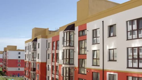Zoom Out View of Modern Apartment Building with Huge Windows and Glass Balconies Located in New