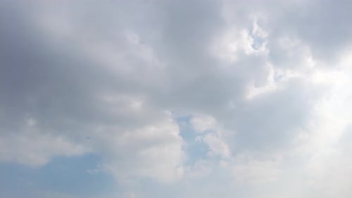 White Clouds Drifting Across a Clear Blue Sky