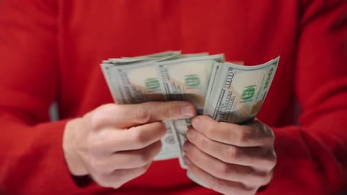 Hands Count Bundles of US Hundred Dollar Bills