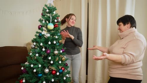 Dancing Near Decorated Christmas Tree for New Year Celebration Enjoying Festive Moments with