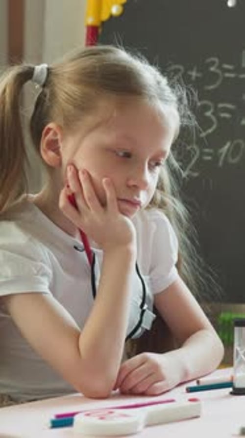 Sad Girl Does Math Homework at School