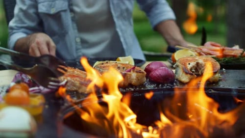 Grilled food on open fire in backyard