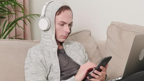 Young Adult Relaxing on Couch with Phone
