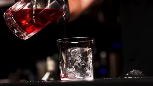 the bartender prepares a cocktail at the bar