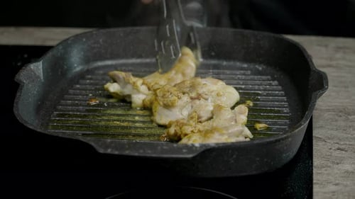 Chicken Thighs Sizzle in Black Grill Pan