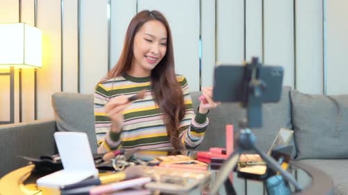 Woman Filming Makeup Tutorial at Home