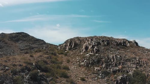 Aerial View of Brown Rocky Mountains and Blue Sky