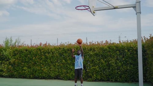 African American Basketball Player Scoring During the Outdoor Training Alone