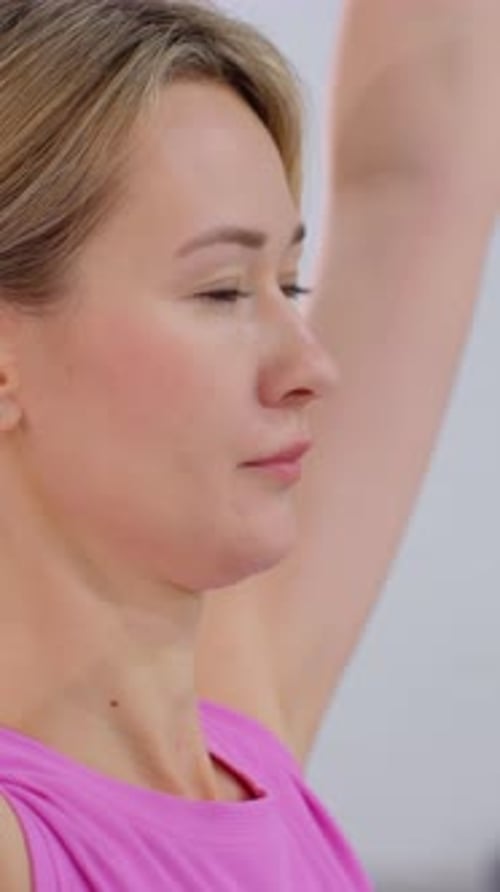Woman raising arms for exercise close up