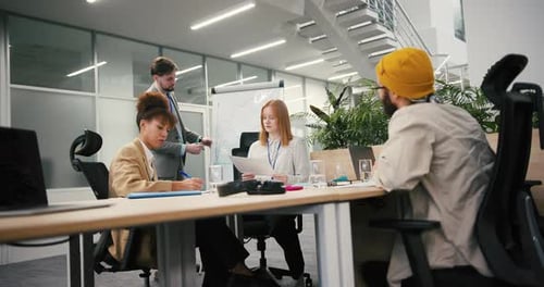 Colleagues Discuss Business Strategy in Modern Office