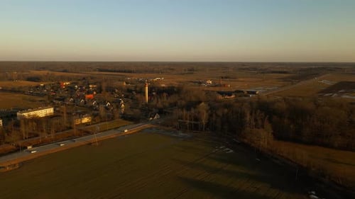 an Aerial View of a Small Town in the Middle of a Field at Sunset
