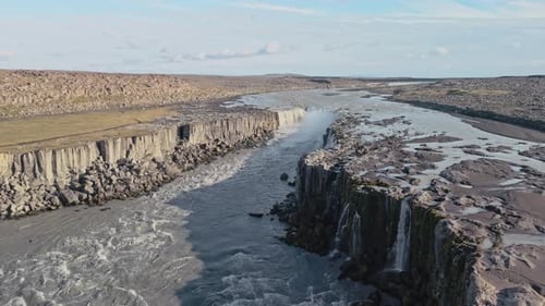 Aerial View Of A Deep Canyon With A River Flowing Through In Iceland