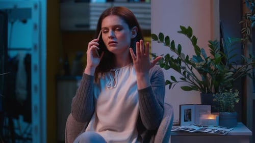 Woman Talking on Phone at Night Indoors