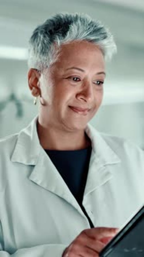 Woman Works On Tablet in Medical Setting