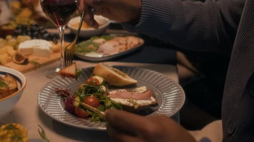 People Enjoying Appetizing Food and Wine at Dinner