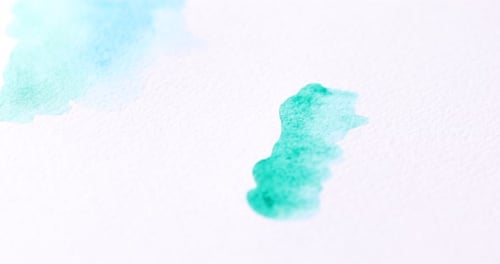 Painting turquoise watercolor with a brush on paper