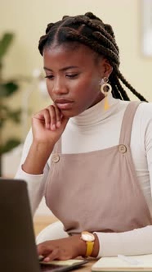 Employee, black woman and typing with laptop at office on research for creative ideas as interior