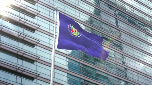 Waving Federated States Of Micronesia Flag With Corporate Building Background